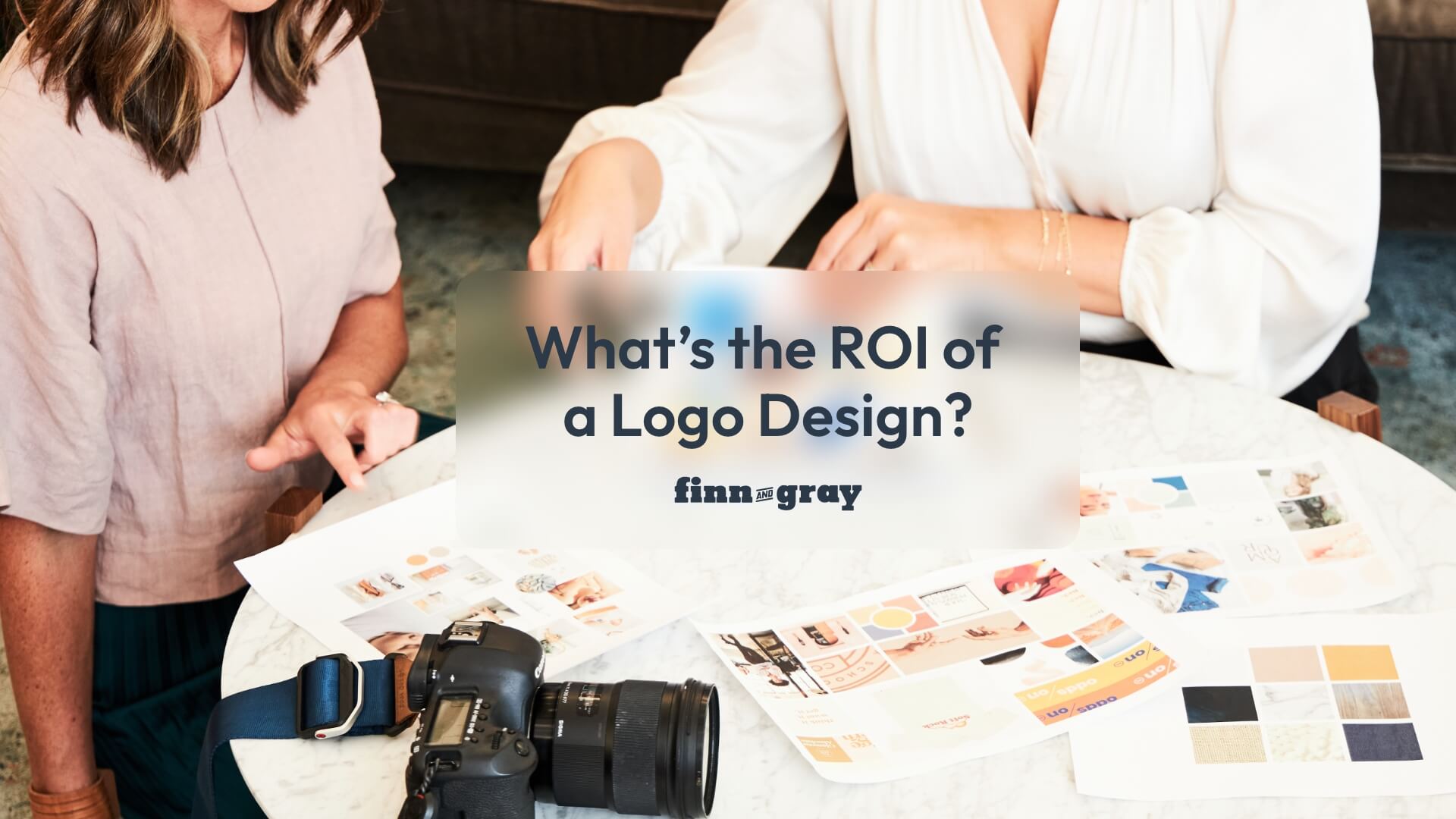 what's the roi of a logo design - question on photo of two women organizing papers